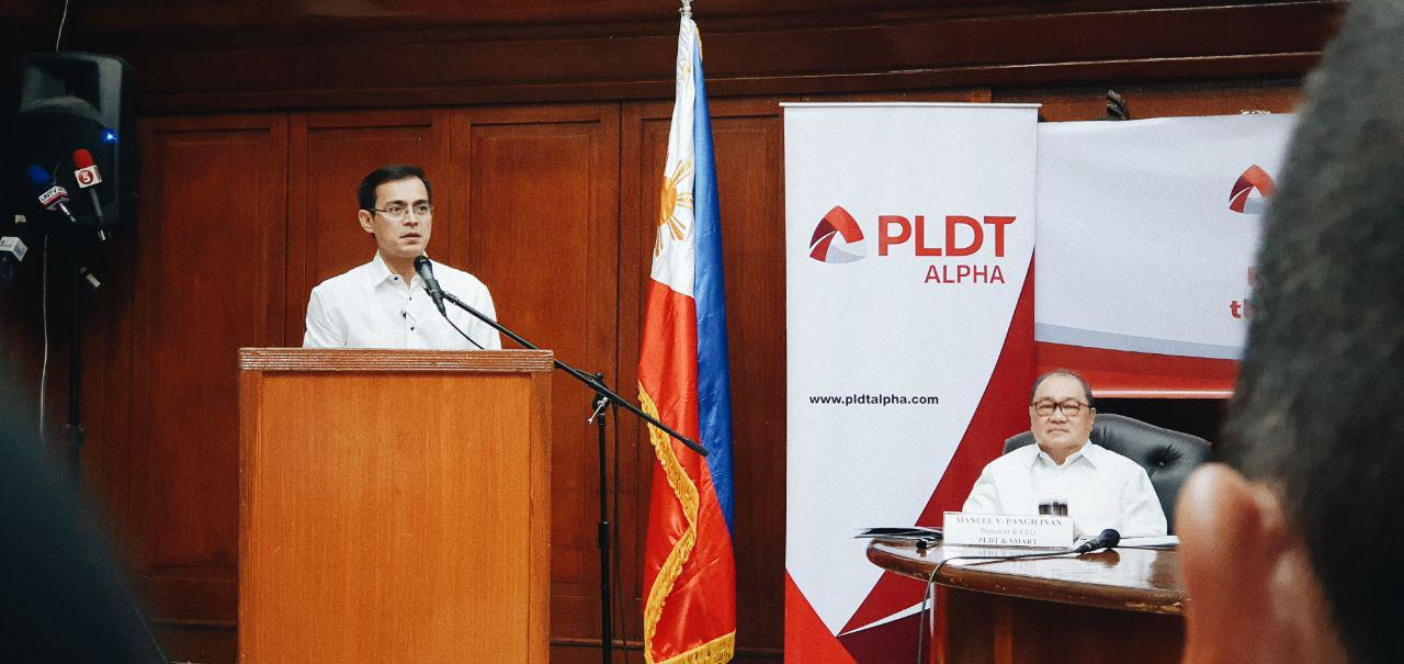 PLDT Chairman and CEO Manny V. Pangilinan listens as Manila Mayor Isko Moreno speaks during the signing of the memorandum of agreement for Smart Wifi at the Manila City Hall on August 7, 2019.