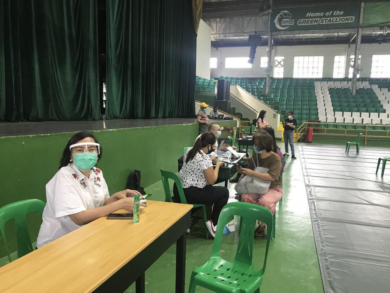 Representatives from PLDT Enterprise, DLSL distribute e-Learning tools to students in preparation for the coming school year.