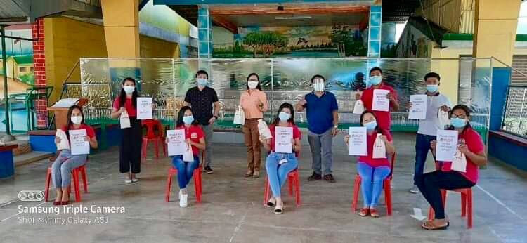 Pula Elementary School teachers and Principal Leah Paulene Escuadro receive hygiene kits from PLDT Tarlac-Nueva Ecija & Aurora CX Zone, represented by Zone Head Ruel Brual and Business Planner Christopher Joshua Galang.