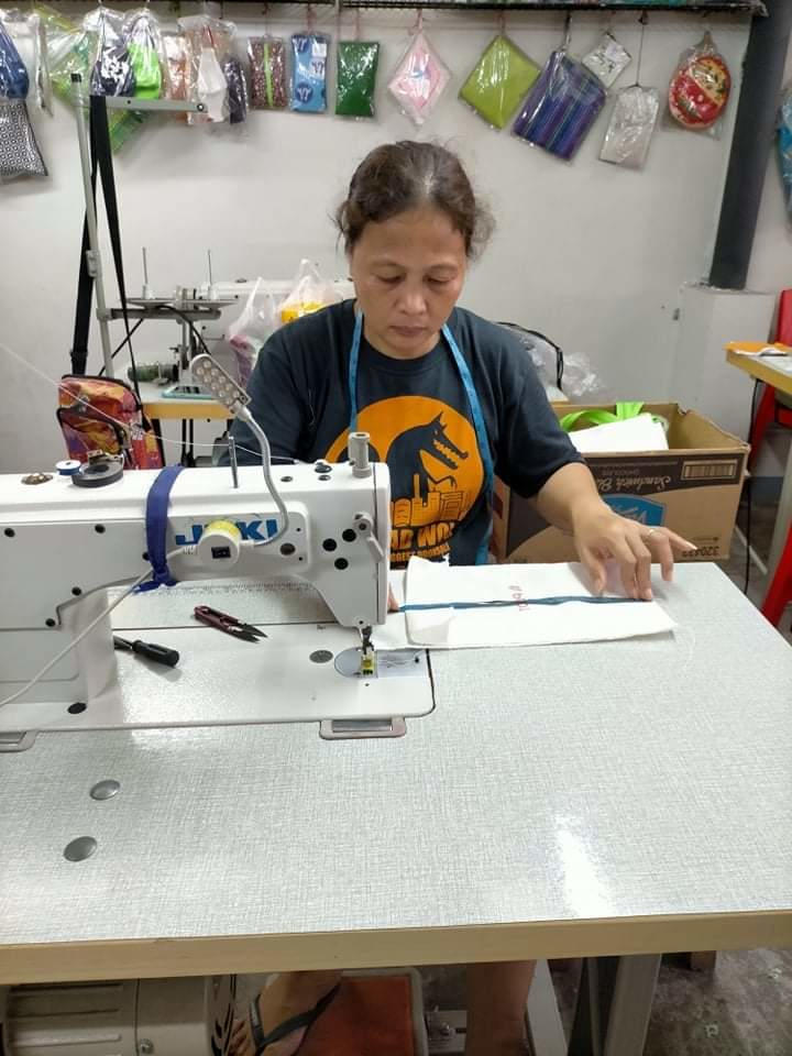 A SOW member sews a PLDT pouch which will be used as a hygiene kit.