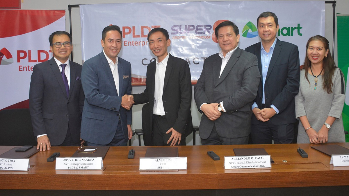 PLDT SVP and Head of Enterprise Business Jovy Hernandez, second from left, and Super 8 CEO Alvin Lim, center, lead the recent partnership event.