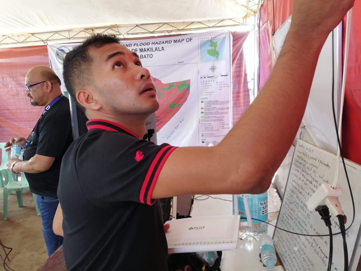 A PLDT GenSan-Cotabato customer experience service delivery associate installs broadband connection at the local government unit’s command center in the earthquake-hit municipality of Makilala in Cotabato