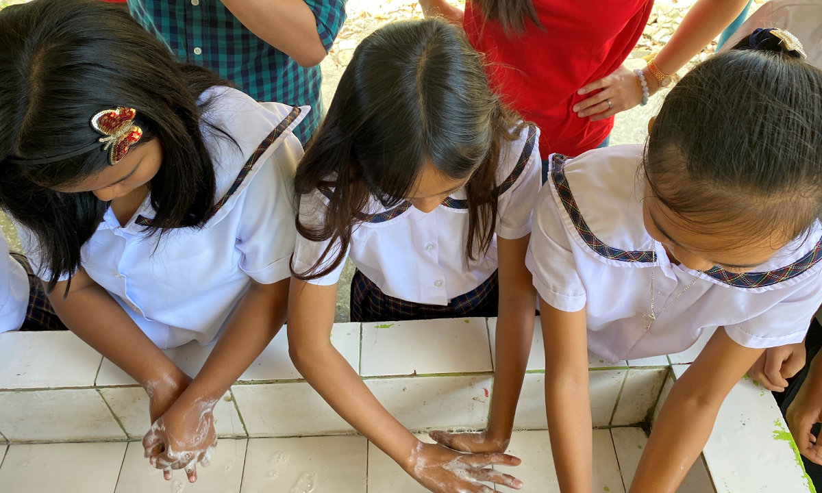 Students wash their hands using the hygiene kits from PLDT.