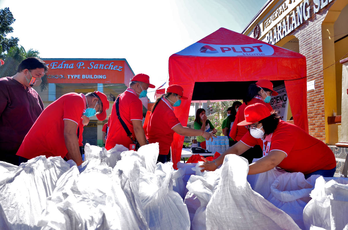 PLDT employee-volunteers prepare the relief packs and hygiene kits for distribution. 