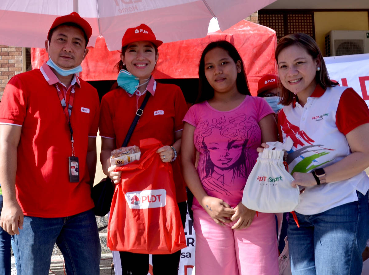 An evacuee receives a relief pack and hygiene kit from PLDT and PLDT-Smart Foundation