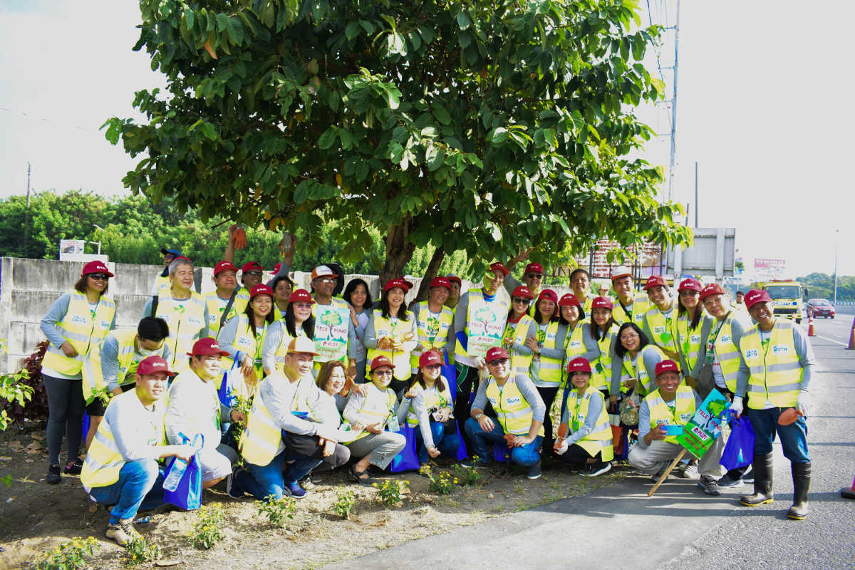 Some PLDT employee-volunteers pose for a group photo after the planting activity.