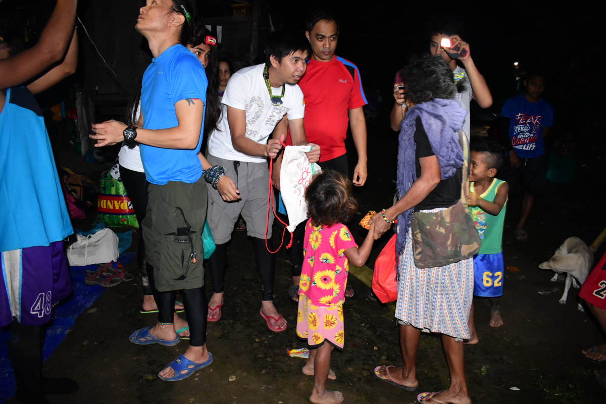 A PLDT MOCI member gives a Sack of Joy bags to beneficiaries.</p>