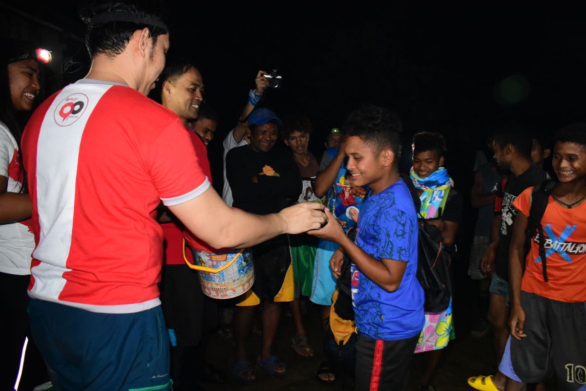 In photo is a mountaineer member distributing some giveaways.