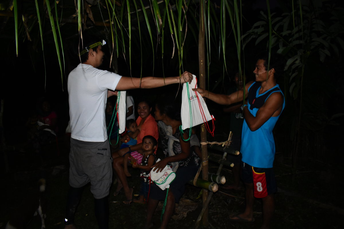 A PLDT MOCI member distributes Sack of Joy bags to members of the Dumagat tribe.